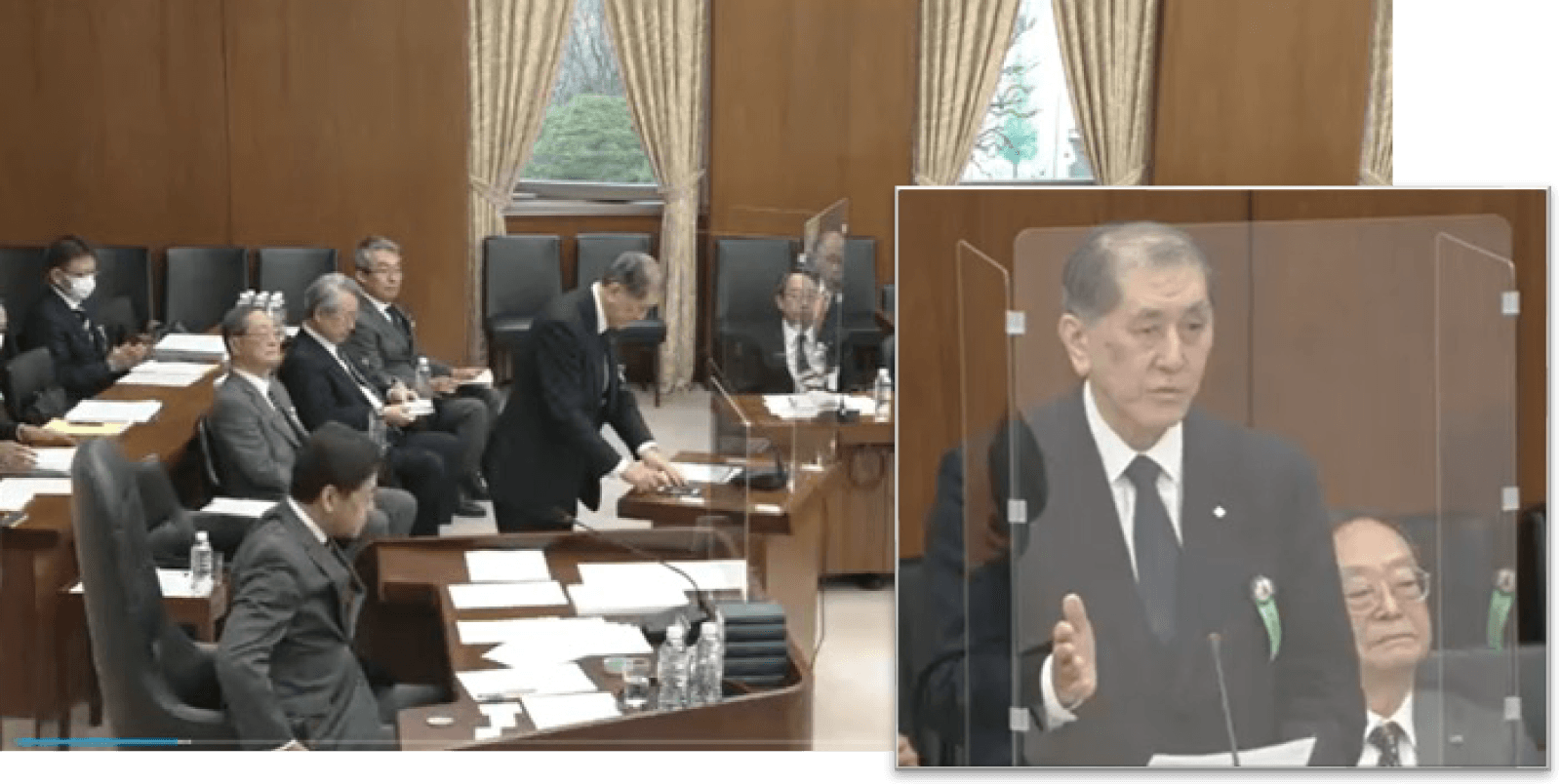 衆議院文部科学委員会の審議中継画面。委員会室の様子に、参考人として答弁する私大連会長の映像が重ねて表示されている。